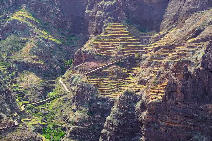 Terraced mountain slopes in Santo Antão's Ribeira Grande, showcasing unique landscapes ideal for hiking tours.