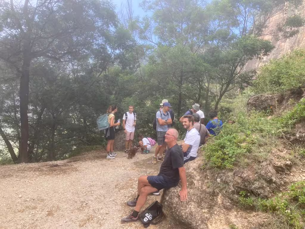 Hikers enjoy a rest in the lush greenery of Santo Antão's Valley of Paul, showcasing the scenic beauty of Cape Verde trekking.