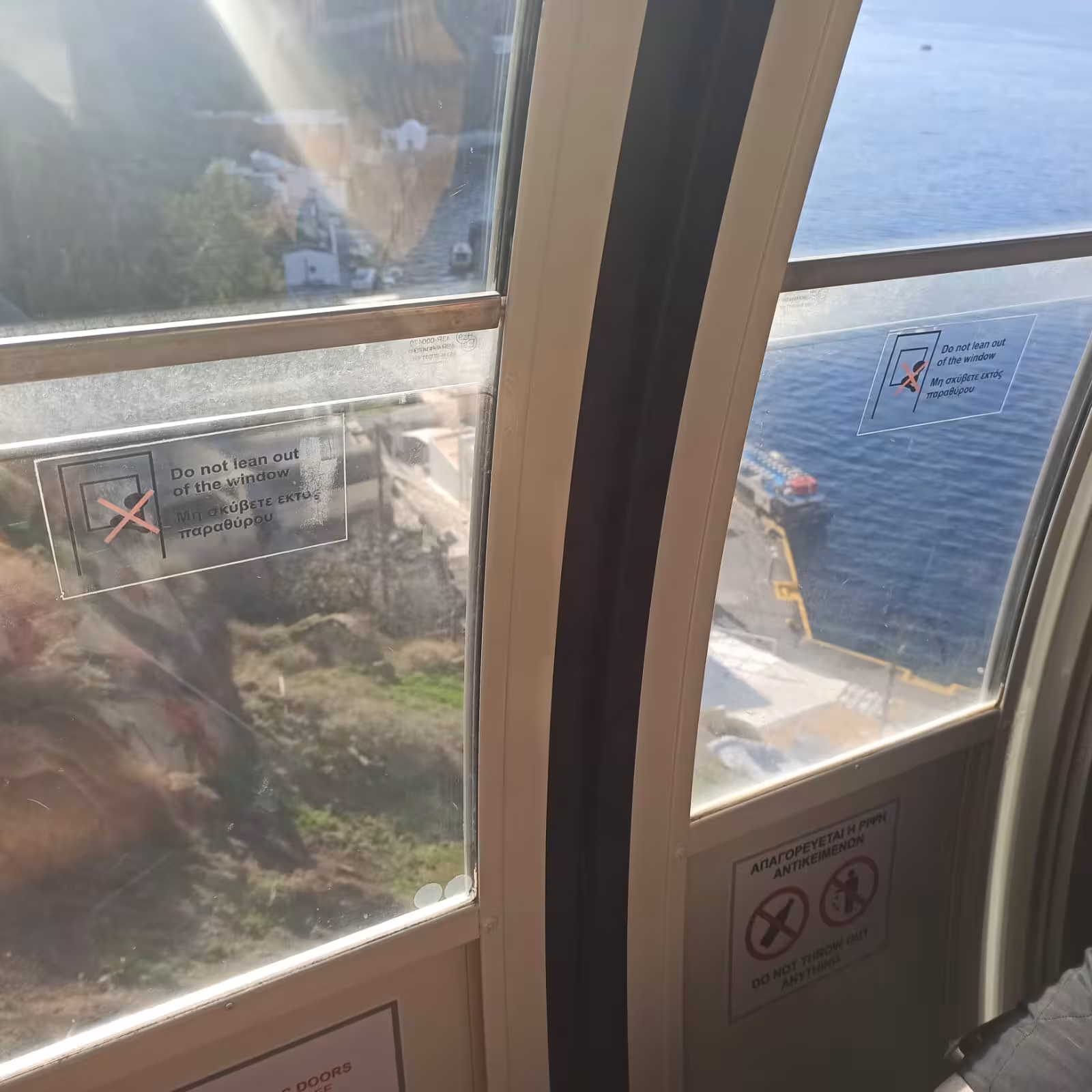 Cable car ride from Santorini cruise port with sea views through windows, transfer on Shore to Oia 5-hour excursion