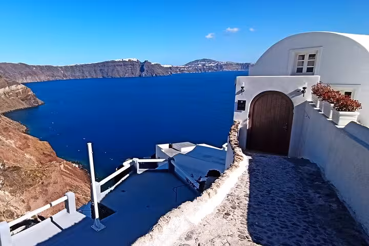 Santorini caldera view by whitewashed cave house in Oia, private day trip from Crete to Santorini