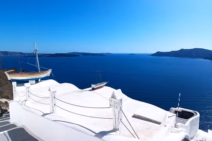 Santorini caldera sea view from white terrace in Oia, ideal for private 3-day tour with transfers