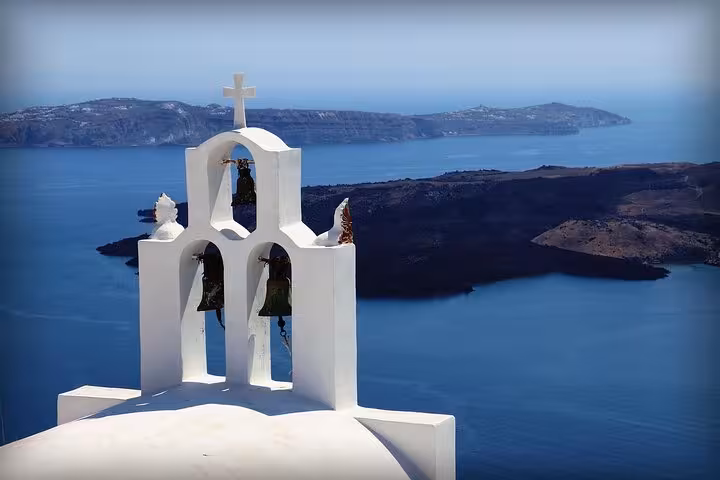 Santorini church bell tower overlooking the caldera and islands, scenic viewpoint on private SUV tour