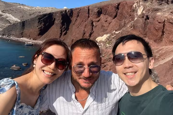 Day trip to Santorini from Crete with private tour and transfers, travelers selfie at Red Beach cliffs