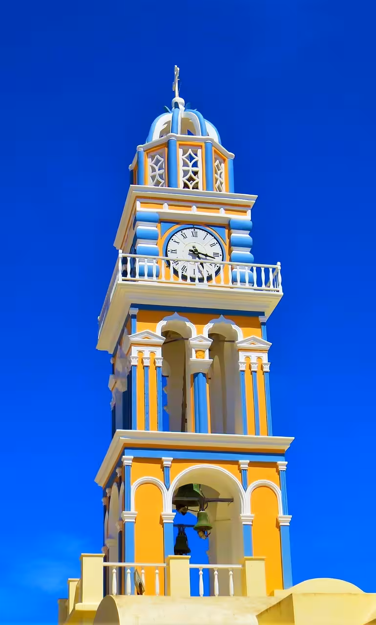 Colorful Santorini church clock tower in Fira, a highlight on the Shore to Oia tour for cruise guests