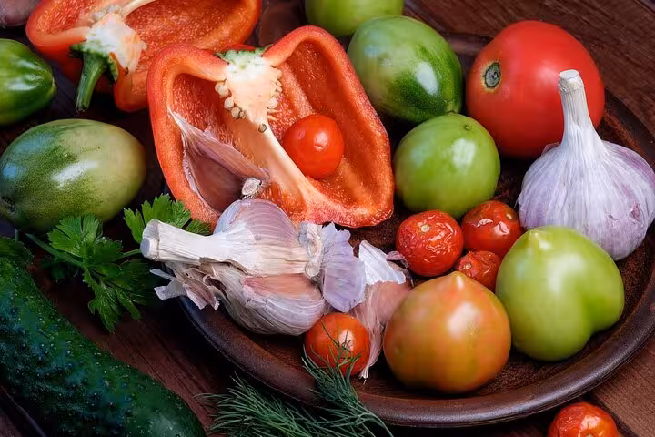 Fresh Greek cooking ingredients—tomatoes, peppers, garlic and herbs—prepped for a Santorini caldera class