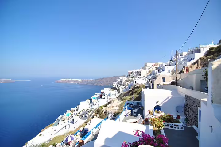 Cliffside Oia village panorama over the caldera, iconic white houses on a private 2-hour Santorini sightseeing tour
