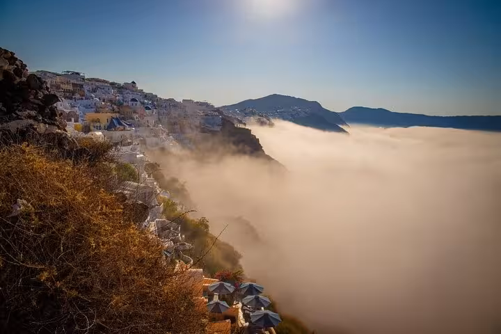 Clifftop Santorini caldera view near Oia with morning mist, ideal cruise port shore excursion photo stop