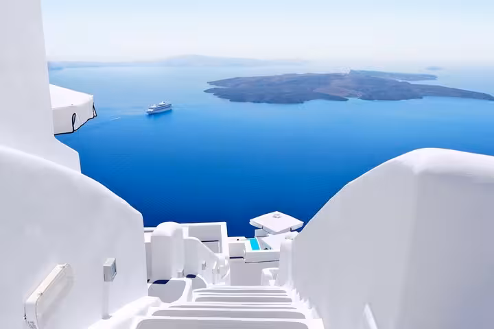 Whitewashed steps with sweeping Santorini caldera views, scenic photo stop on Oia Pyrgos Imerovigli tour