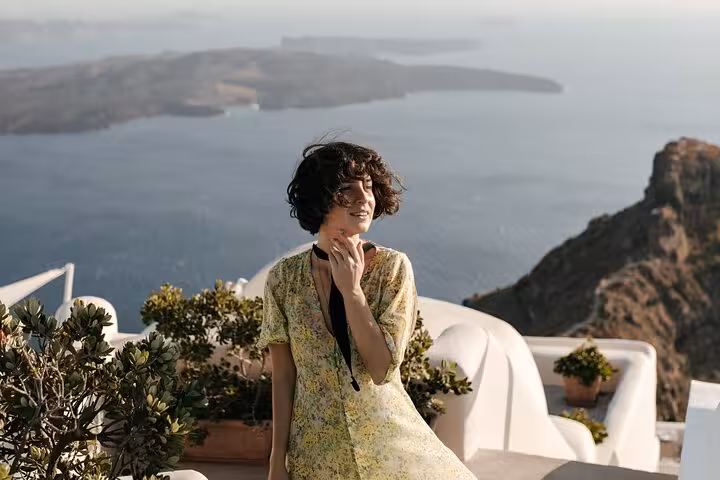 Traveler enjoying Santorini caldera view from Oia terrace, perfect stop on a private SUV hidden gems tour