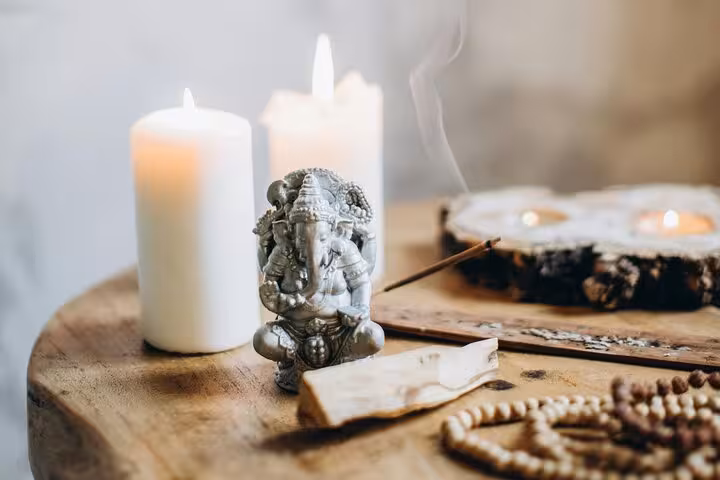 Candles, incense and meditation altar setup for Santorini Serenity Yoga, mindful relaxation by the caldera