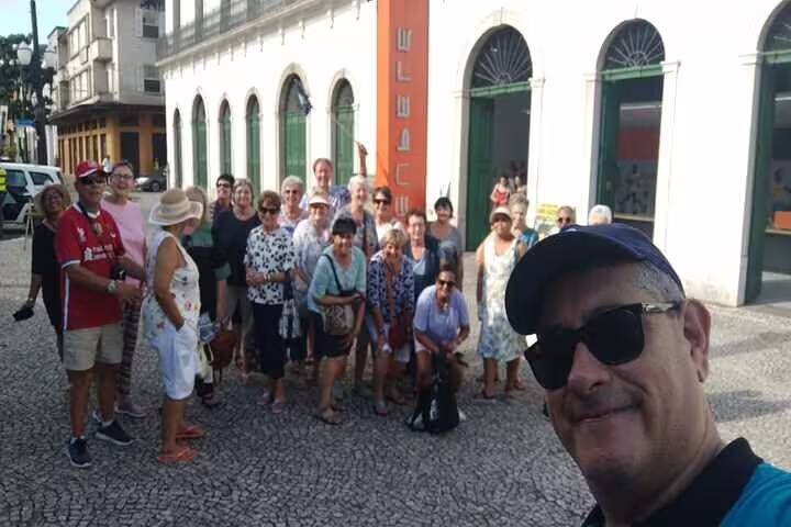 Tourists gather for a selfie outside the Santos coffee museum on a shared full-day beach excursion.