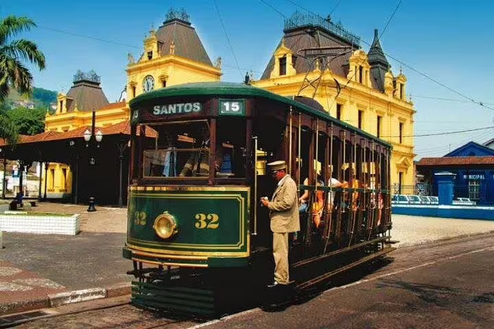 Historic tram in Santos passing by vibrant colonial architecture during the 10-hour Santos beach tour with lunch.