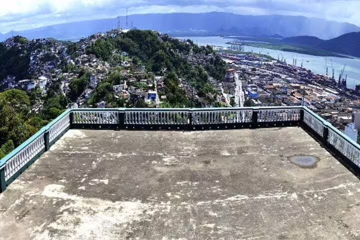 Panoramic view from a scenic lookout in Santos capturing lush hills and vibrant port city during a full-day beach tour.