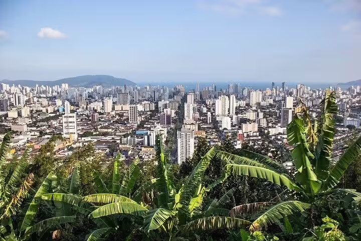 Scenic view of Santos city skyline and lush greenery from a high vantage point on a full-day beach tour.