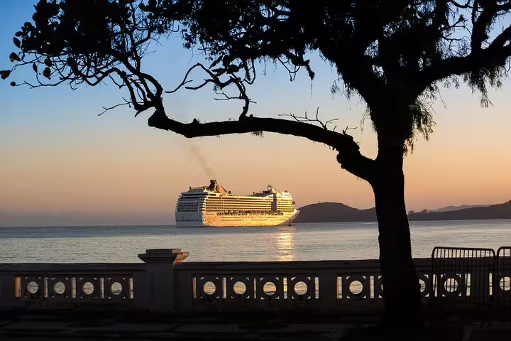 Scenic view of a cruise ship at sunset in Santos, Brazil, highlighting the serene coastal beauty on the Mont Serrat tour.