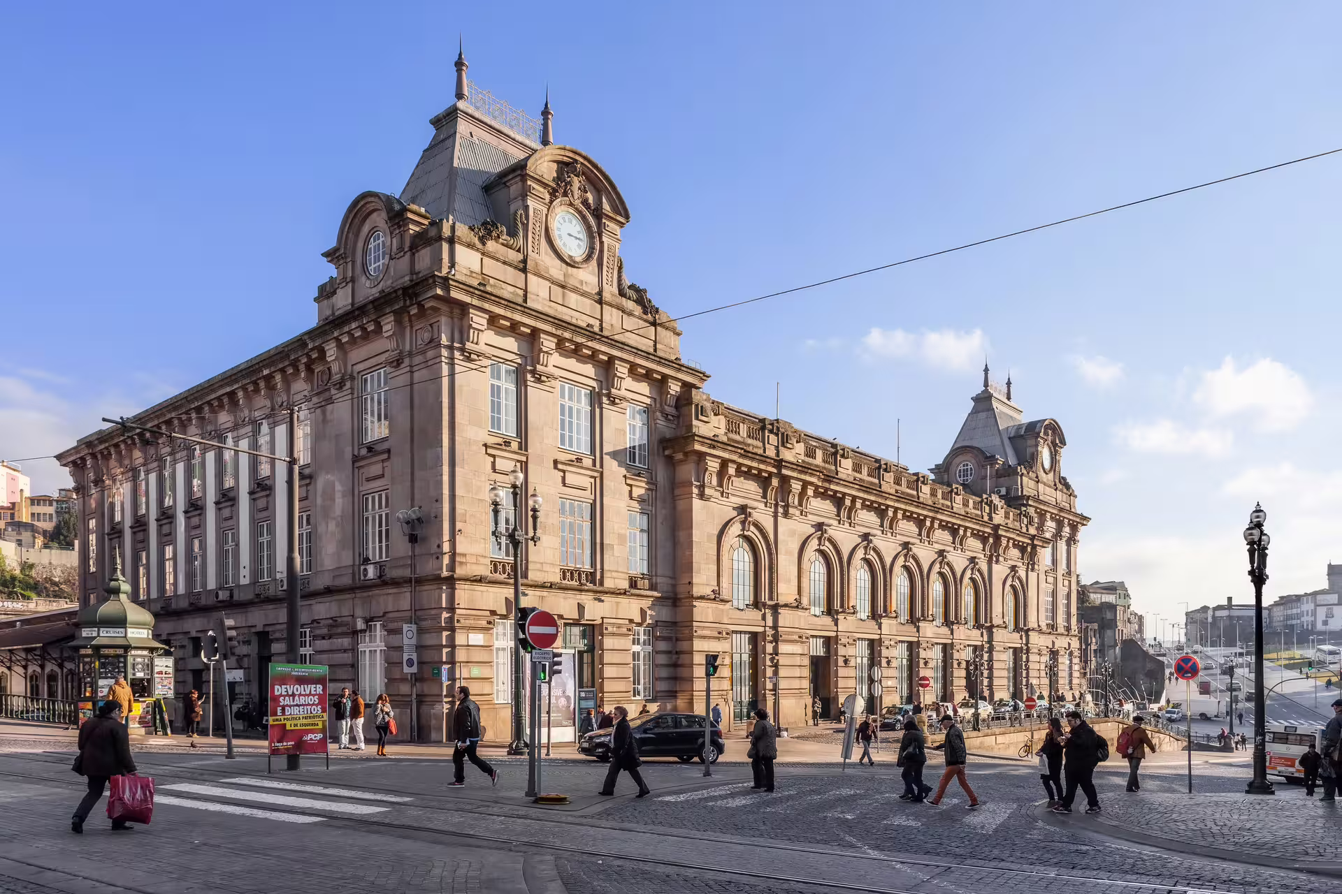 The historic São Bento Railway Station in Porto, bustling with pedestrians on a sunny day during the city tour.