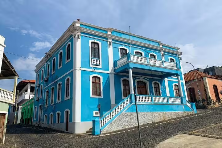 Stately blue colonial building with arched windows in São Filipe, perfect for exploring Cape Verde's architectural heritage.