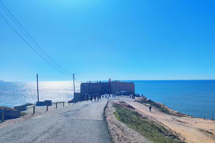 Path leading to the historic Fort of São Miguel Arcanjo with ocean view in Nazaré, Portugal.