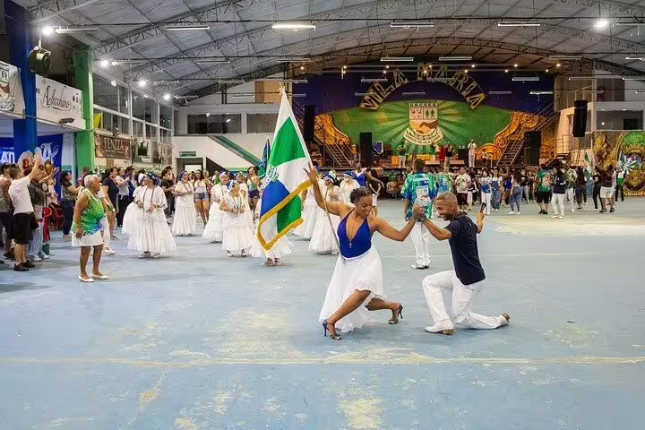Dancers perform a vibrant samba routine during a São Paulo Carnaval rehearsal, showcasing cultural music and lively costumes.