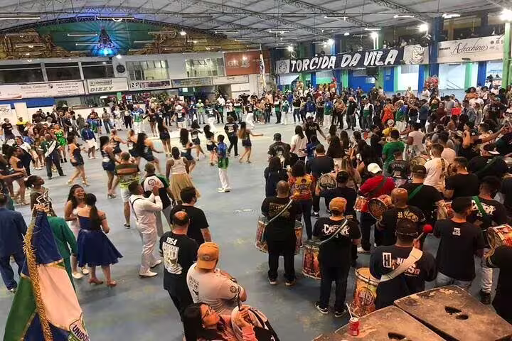 Vibrant São Paulo Carnaval rehearsal with dancers and drummers energizing the samba school atmosphere.