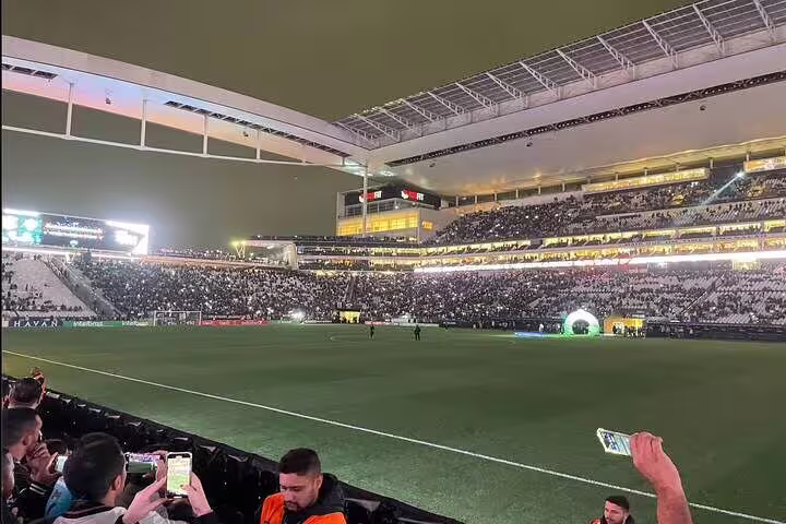 Nighttime football match at São Paulo's stadium, capturing the energy and excitement of live sports under bright lights.
