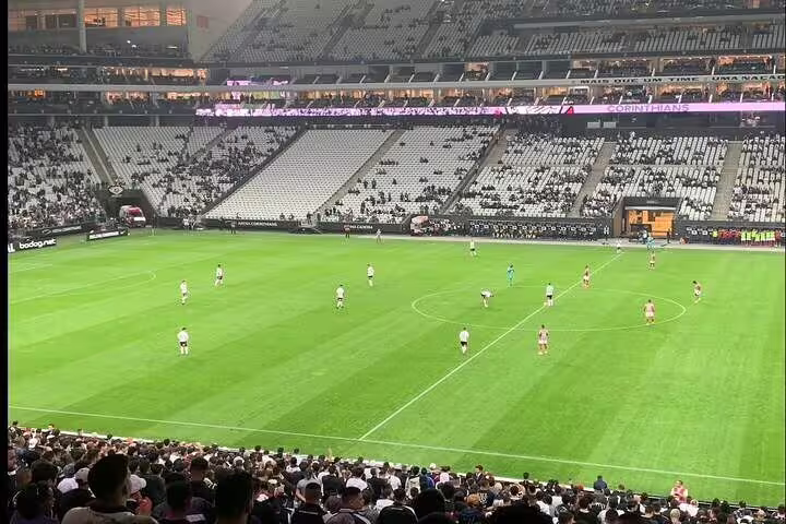 Spectators enjoying an exciting football match at São Paulo's stadium, showcasing vibrant sports culture and atmosphere.