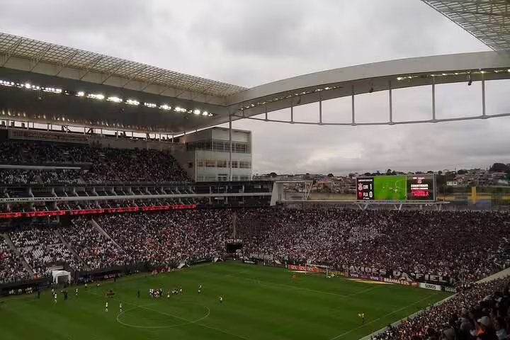 A thrilling football game underway at São Paulo's stadium, filled with enthusiastic fans and a lively match environment.