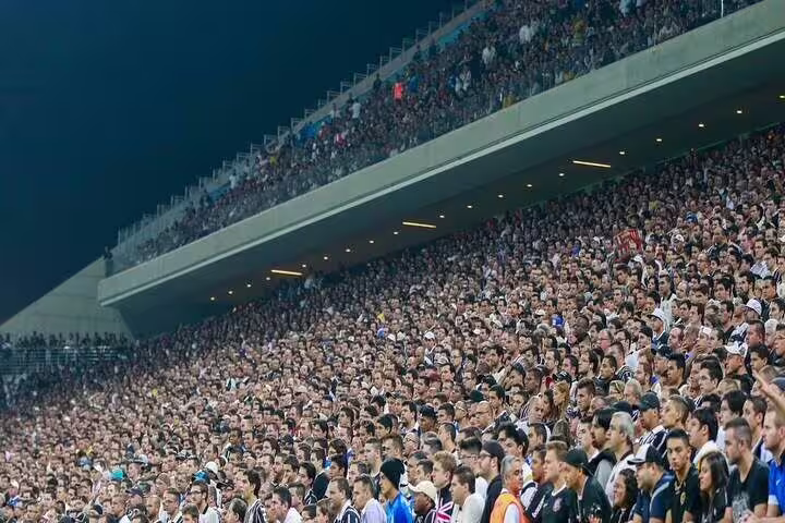 A packed stadium in São Paulo with enthusiastic fans, highlighting the vibrant atmosphere of a live football match.
