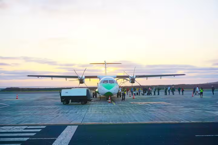 São Vicente airport arrivals with turboprop plane at sunset, meet-and-greet private transfer to São Pedro