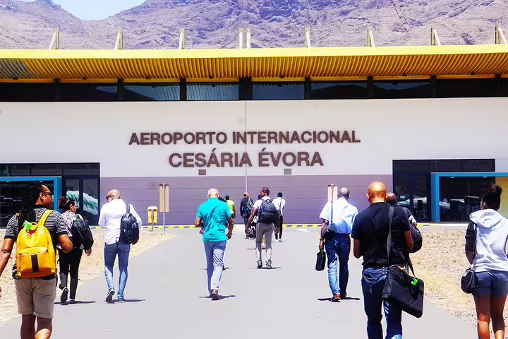 Travelers walking to Cesária Évora International Airport, start point for São Vicente private transfer to Baía das Gatas