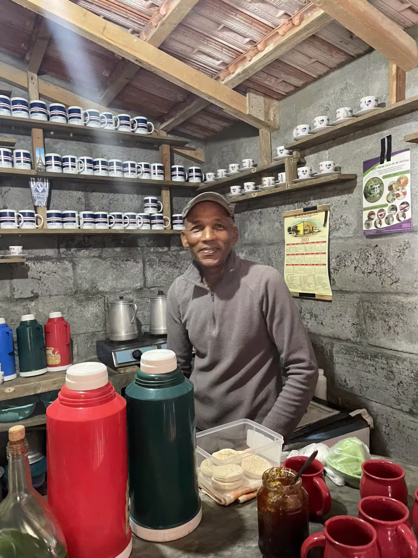 Local vendor in São Vicente showcasing traditional Cape Verdean pottery and refreshments on the Half Day Best of Mindelo tour.