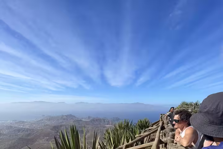 Tourists explore stunning São Vicente landscapes from a wooden viewpoint during the Half Day Best of São Vicente tour.