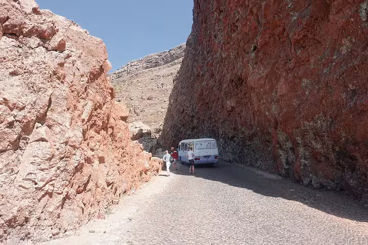 Tour van navigating through the rugged red rock landscapes of São Vicente during the Discovery of Sal tour.