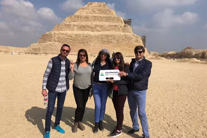 Visitors at Saqqara Step Pyramid on Cairo day trip combining Giza Pyramids, Memphis and Saqqara tours