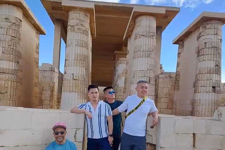 Travelers at Saqqara temple columns on private Cairo tour with Grand Egyptian Museum, Memphis and lunch