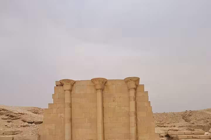 Ruins of Saqqara temple wall with columns in Egypt desert, part of Saqqara & Giza Pyramids day tour