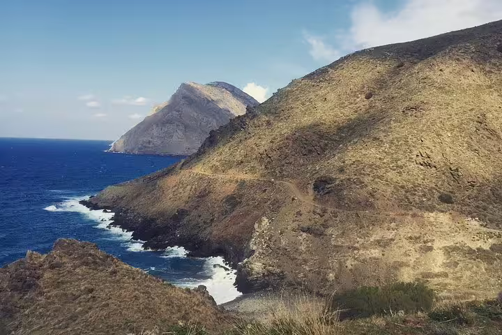 Breathtaking view of the South Coast's rugged cliffs meeting the blue sea near Sarakina Gorge in Kritza.