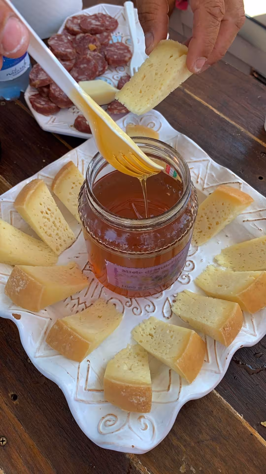 Sardinian cheese and honey platter with cured meats, enjoyed during the La Maddalena Archipelago speedboat tour.