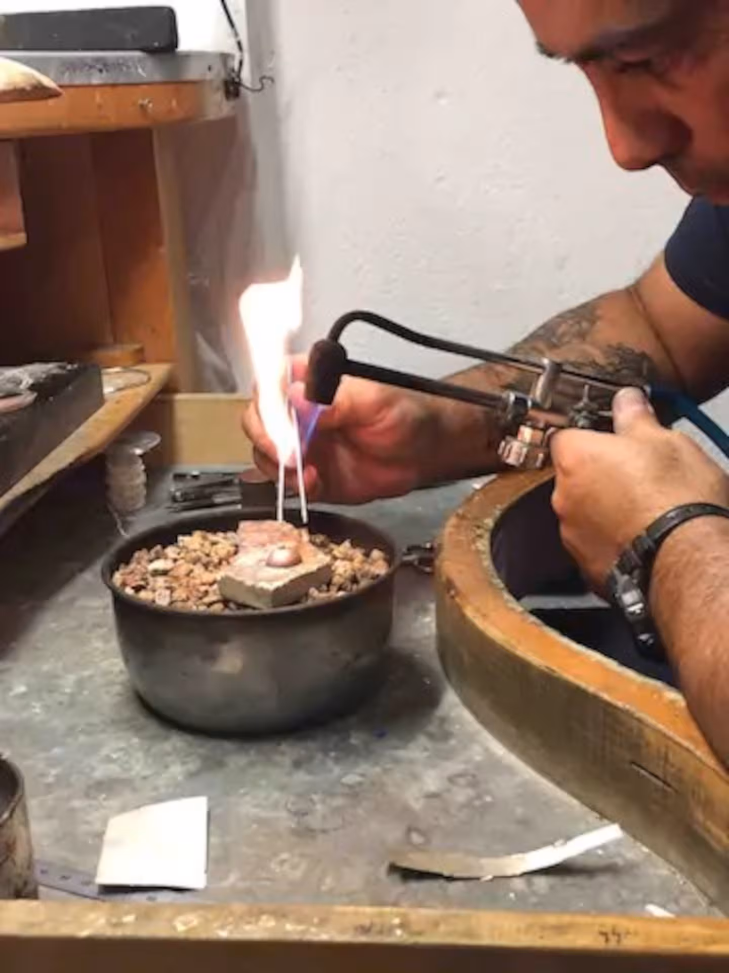Artisan using a torch to craft intricate designs in a Sardinian filigree workshop in Dorgali.