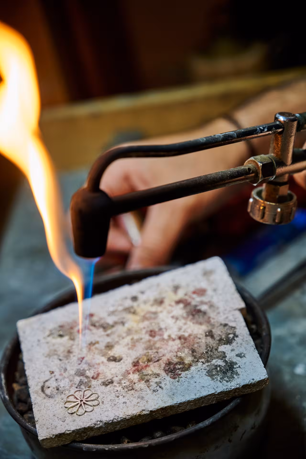 Sardinian filigree flower being carefully soldered by a flame in a Dorgali goldsmith's workshop.