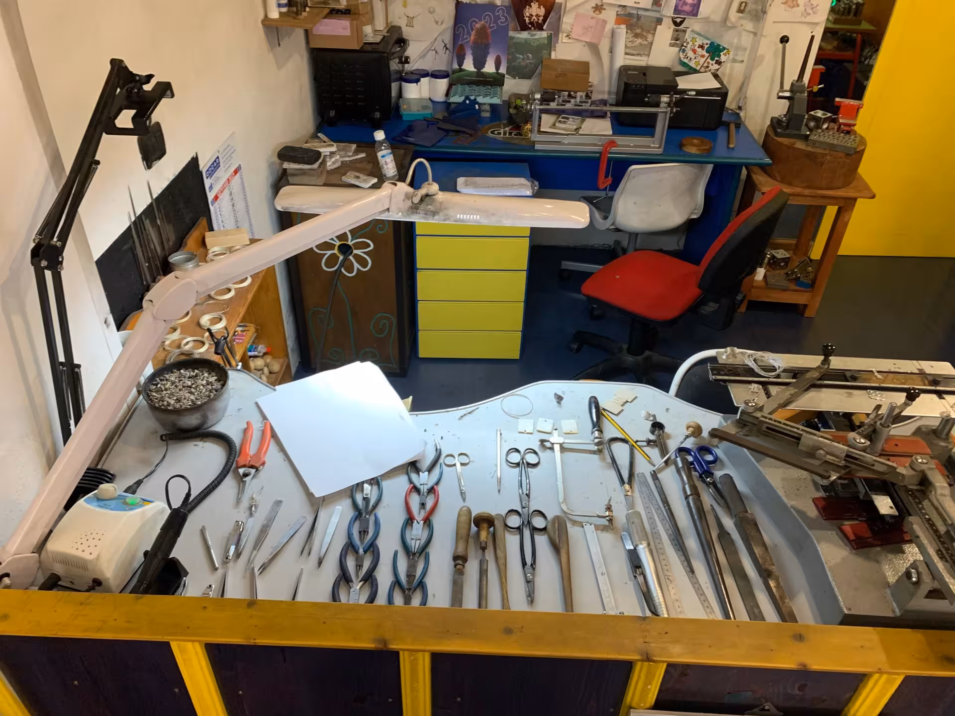 Close-up of a goldsmith's workstation in Dorgali, displaying tools and equipment used in Sardinian filigree craftsmanship.