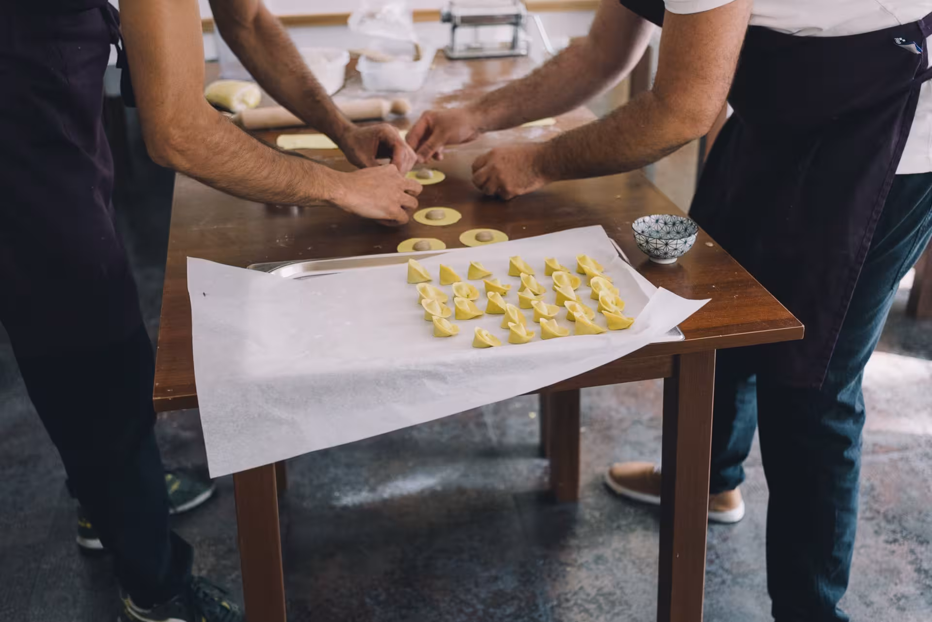 Hands crafting traditional Sardinian pasta during a tapas tasting workshop in Olbia.