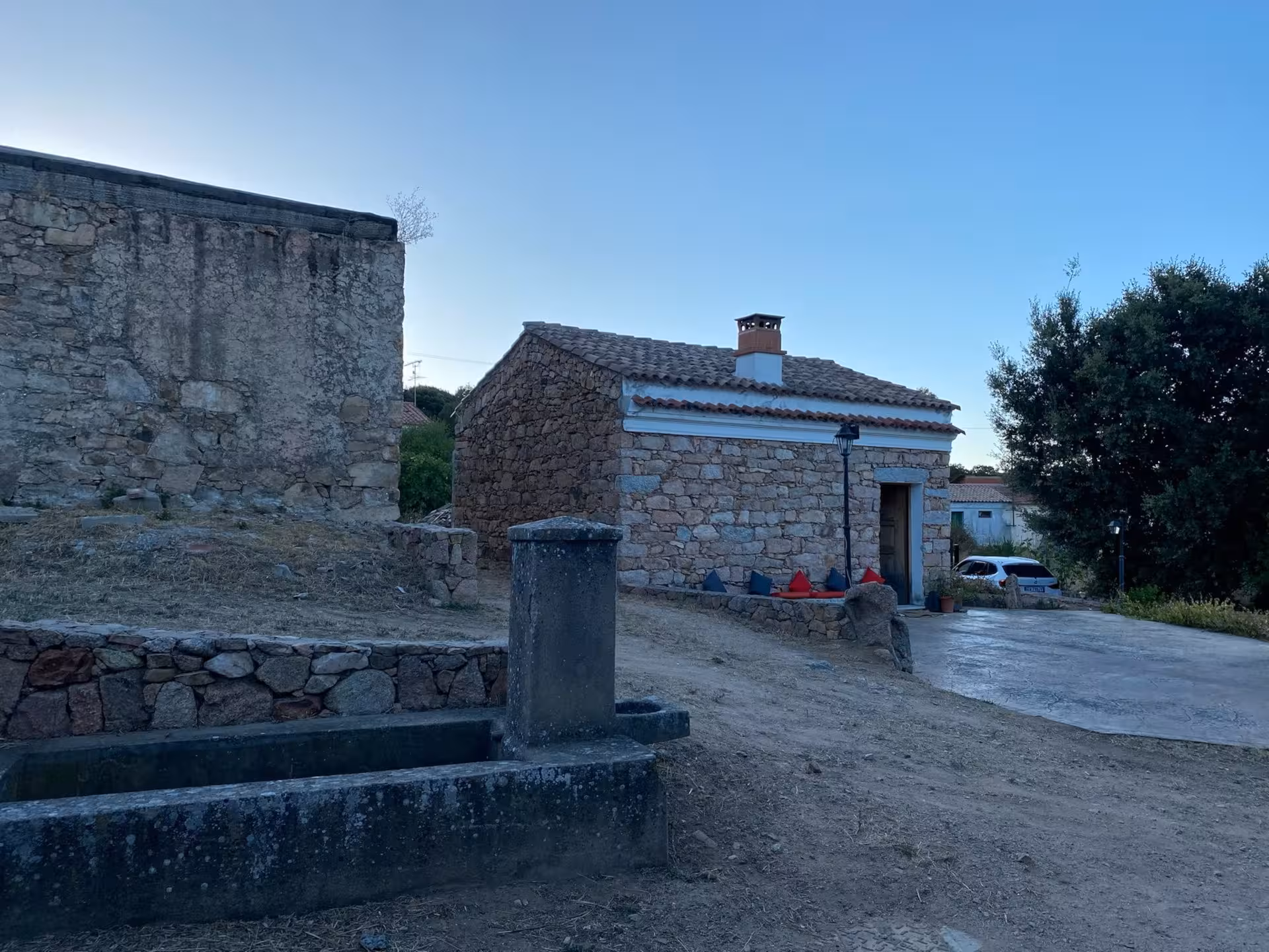 Picturesque stone buildings in an ancient Olbia village, ideal location for a traditional Sardinian pasta workshop.