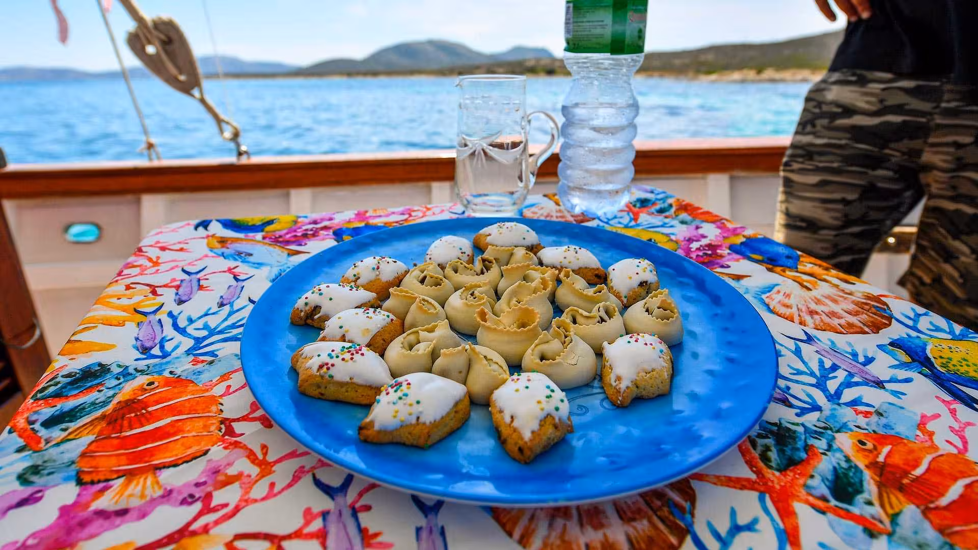 Traditional Sardinian sweets served on a sailing tour to Asinara, highlighting local flavors against a scenic seascape.
