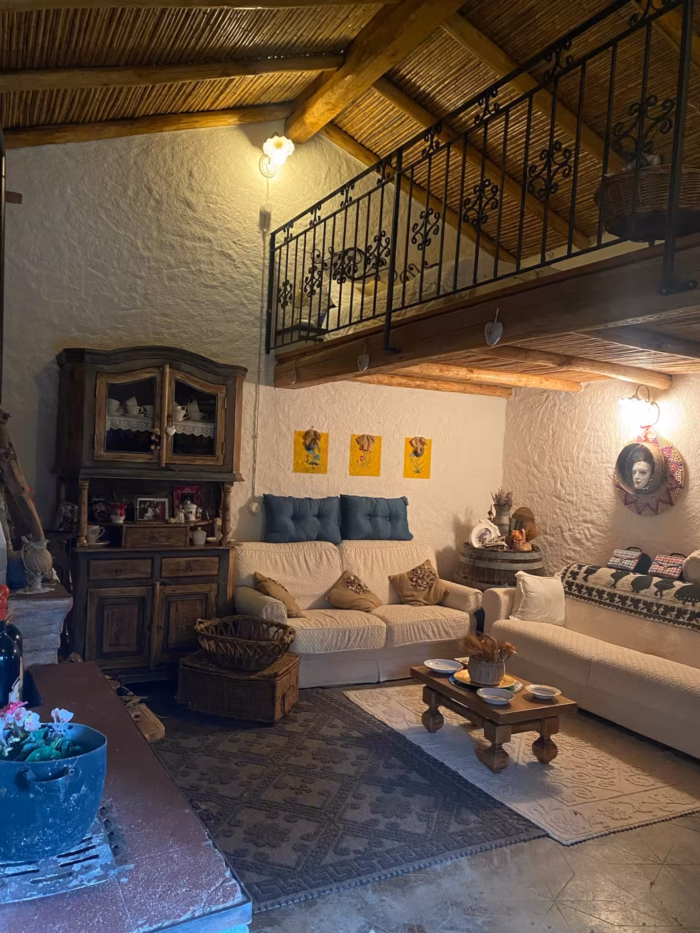 Cozy living area with vintage furniture in a historic Sardinian village house in Olbia.