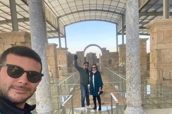 Visitors explore the ancient ruins of Sardis, a highlight of the 7 Churches of Revelation Tour, under a modern shelter.