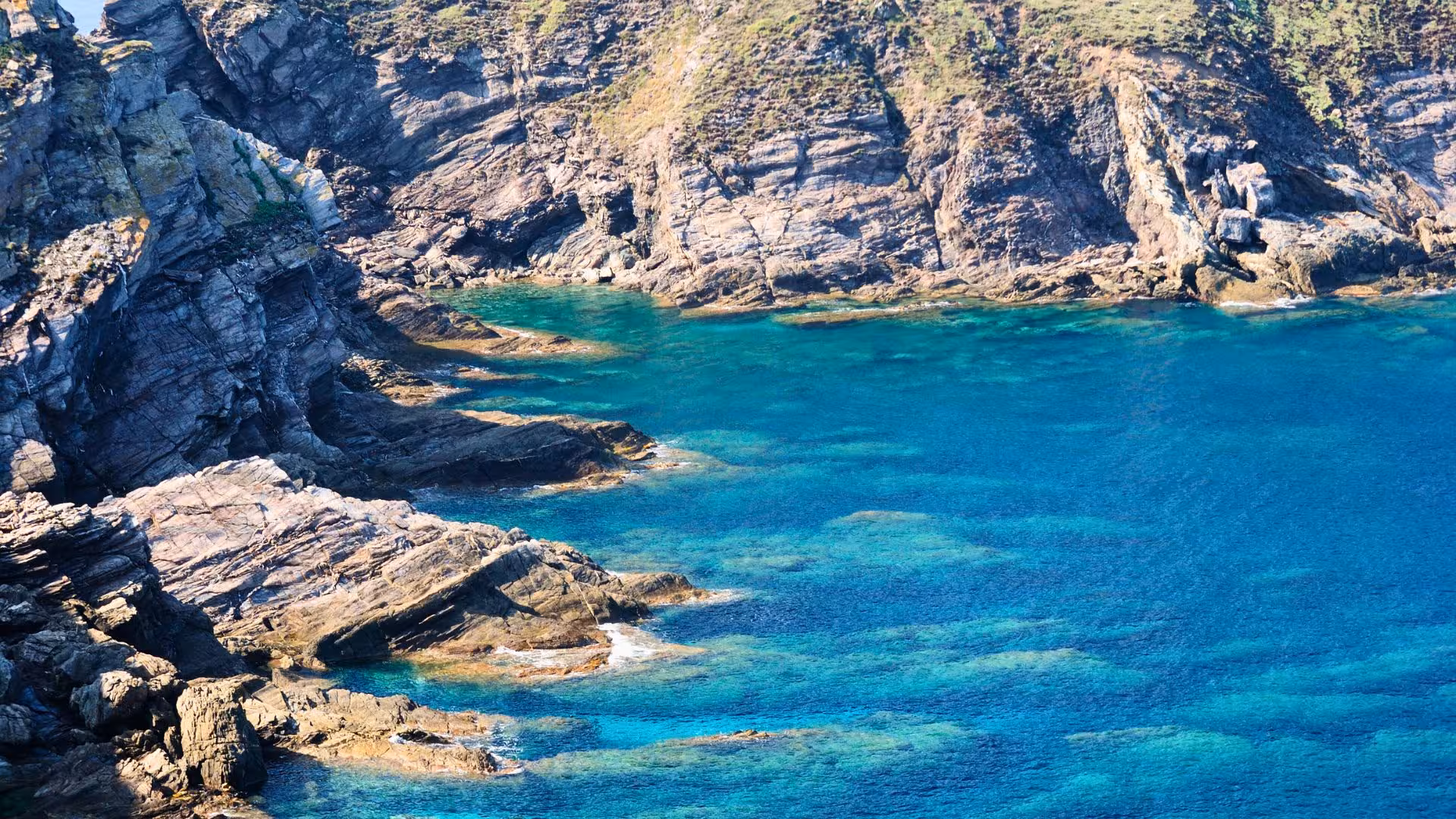 Explore Sassari's stunning Argentiera coast with clear turquoise waters and rugged rock formations perfect for diving.