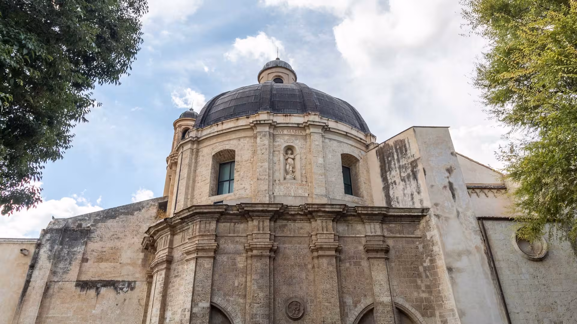 Stunning historic dome of a church in Sassari, showcasing intricate stonework and architectural elegance.