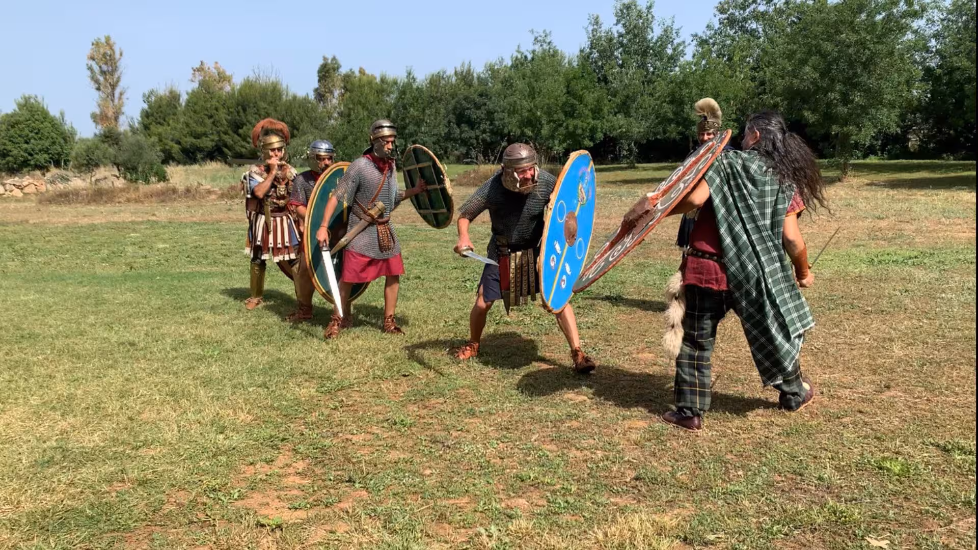 Reenactors in Roman armor engage in a mock battle at the Sassari Roman Castrum educational farm.