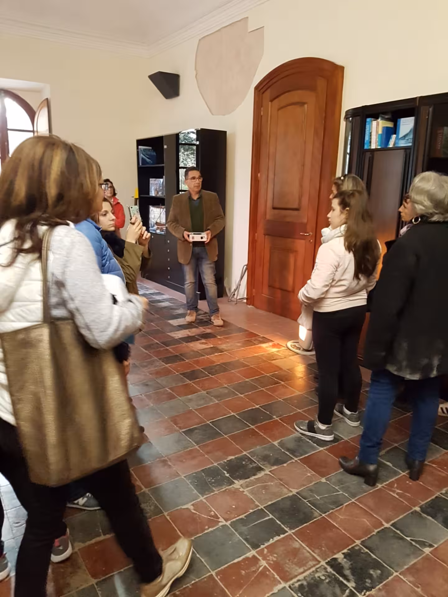 Visitors engage in a guided tour inside Sassari's Sea and Water Ecomuseum, exploring cultural exhibits and history.
